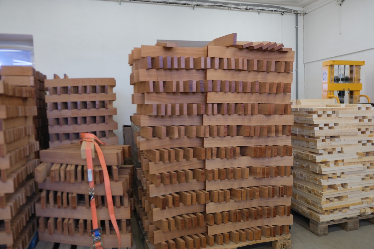 A stack of mahogany neck blanks await machining